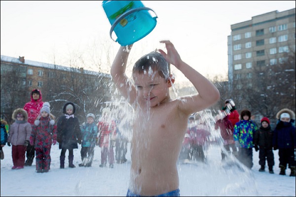 Siberian children pour ice water on their heads while standing in swimsuits in snow for ONE reason (this is NOT a punishment)