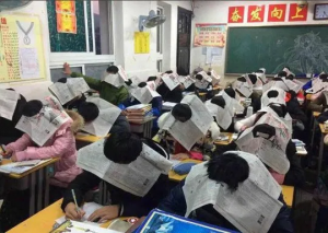 Hangzhou kids wear social distancing hats upon return to school